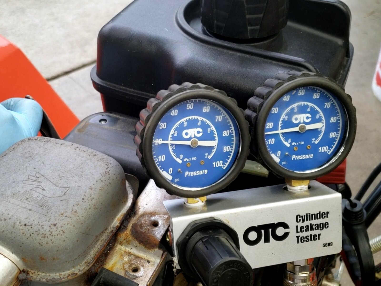 Leak-down test on an Ariens snowblower with a Briggs engine showing a head gasket leak