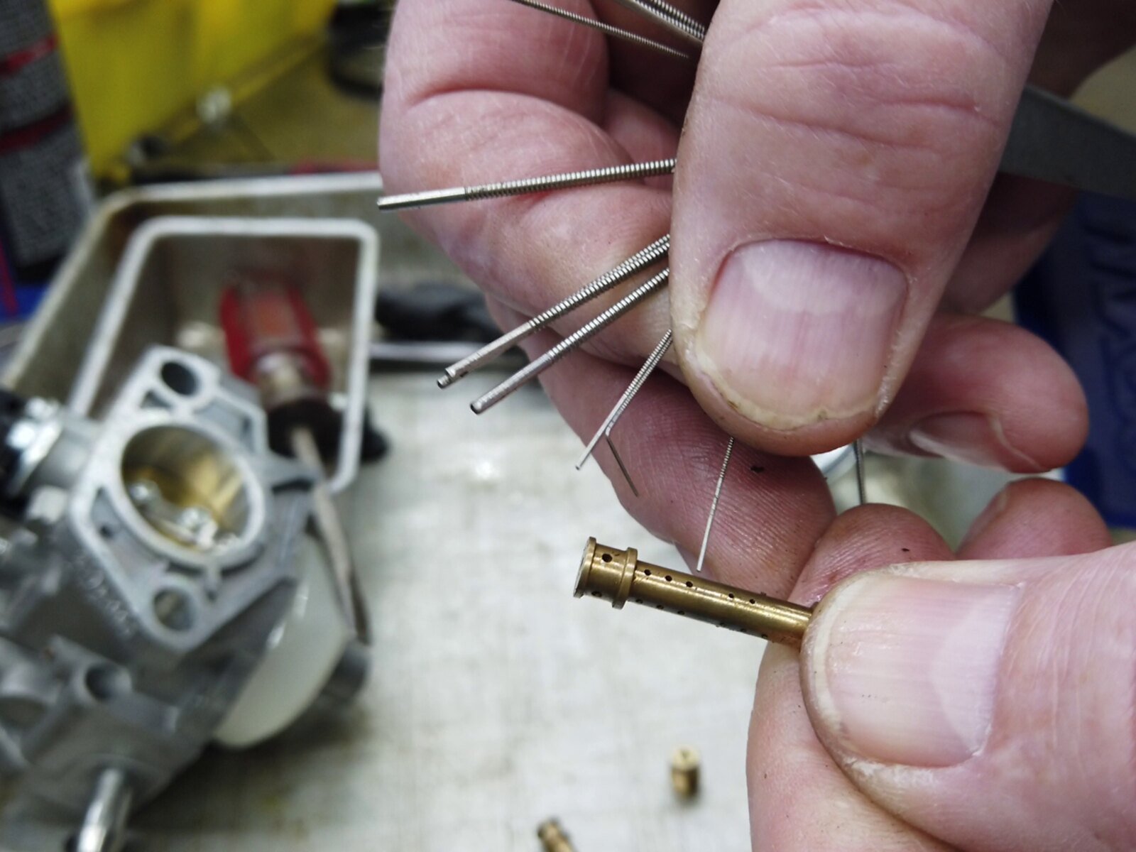 Cleaning and inspecting small calibrated passages in a carburetor emulsion tube