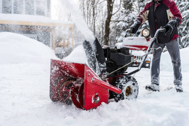 Senior Man Using SnowBlower After a Snowstorm, Quebec, Canada